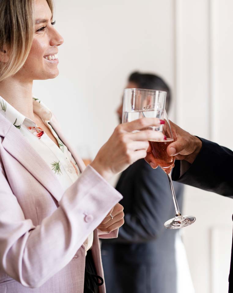 woman toasting glass at network event