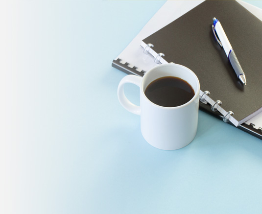 notebook and coffee on table